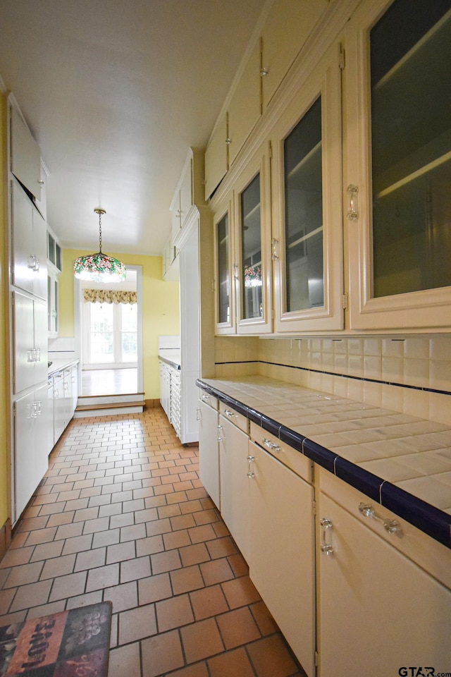 510 E Longview St, Arp, TX 75750 - kitchen with tasteful backsplash, hanging light fixtures, glass insert cabinets, and tile counters