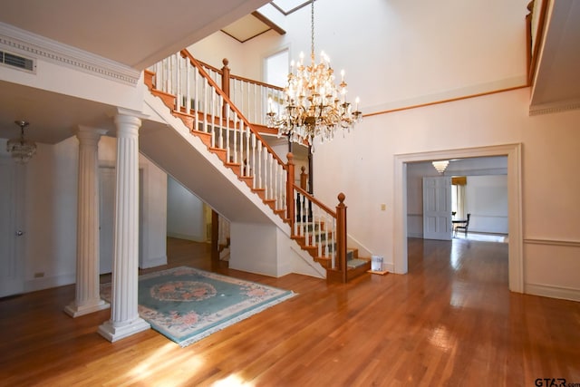 510 E Longview St, Arp, TX 75750 - stairway featuring wood finished floors, a chandelier, baseboards, and a towering ceiling