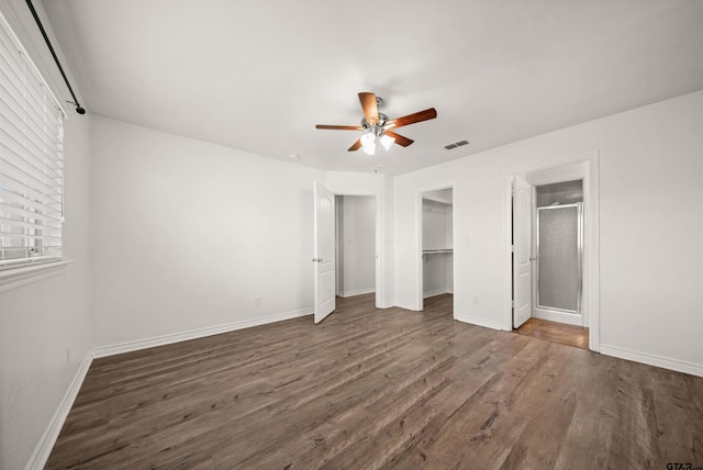 unfurnished bedroom featuring ceiling fan, a closet, and dark wood-type flooring