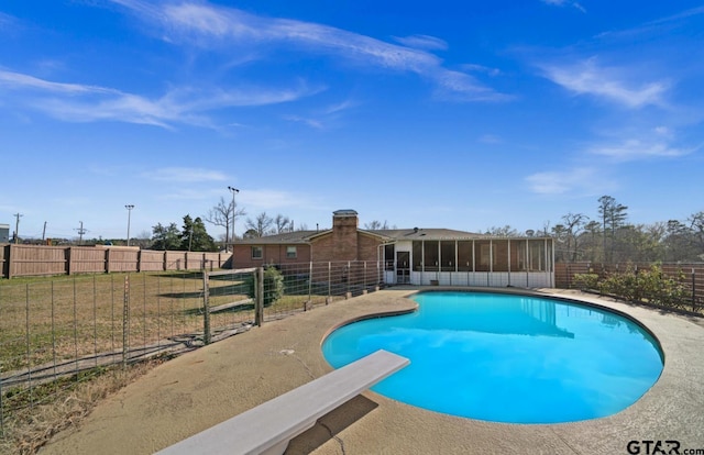 view of pool featuring a sunroom and a diving board