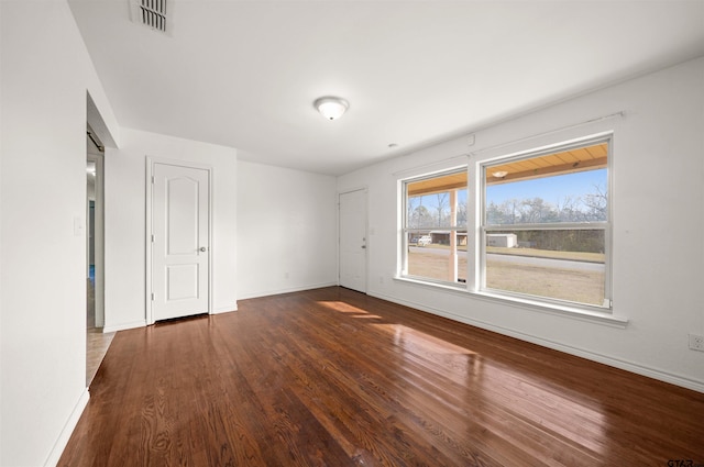 empty room with dark hardwood / wood-style floors