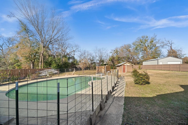 view of swimming pool with a yard and a storage unit