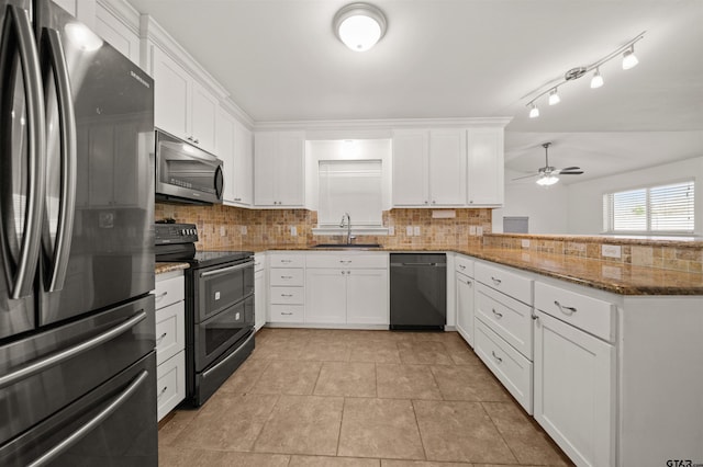 kitchen with tasteful backsplash, dark stone countertops, black appliances, white cabinets, and sink