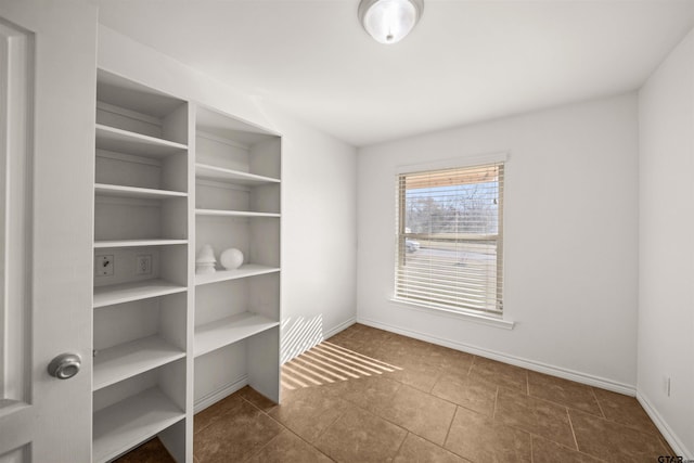 empty room featuring dark tile patterned flooring