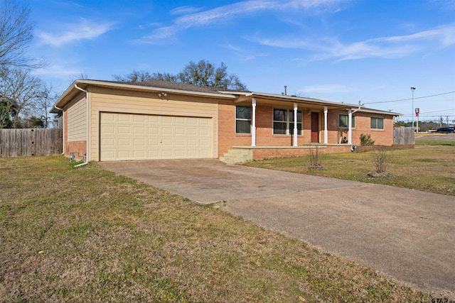 ranch-style home featuring a garage, covered porch, and a front yard