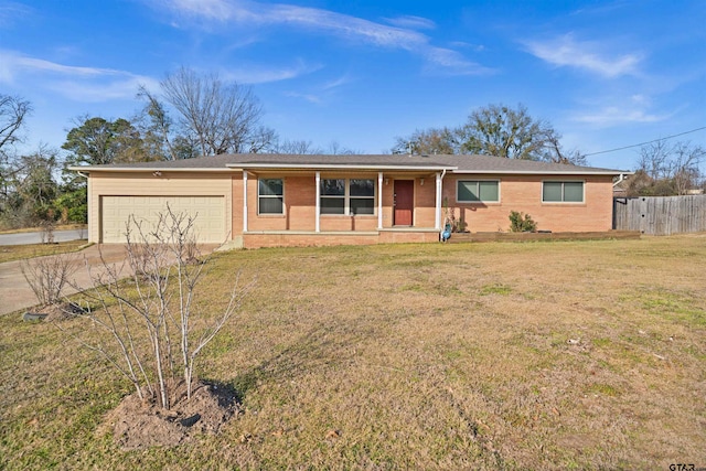 ranch-style home featuring a garage, a front lawn, and covered porch