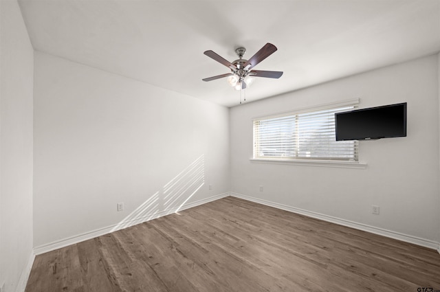 empty room with ceiling fan and wood-type flooring