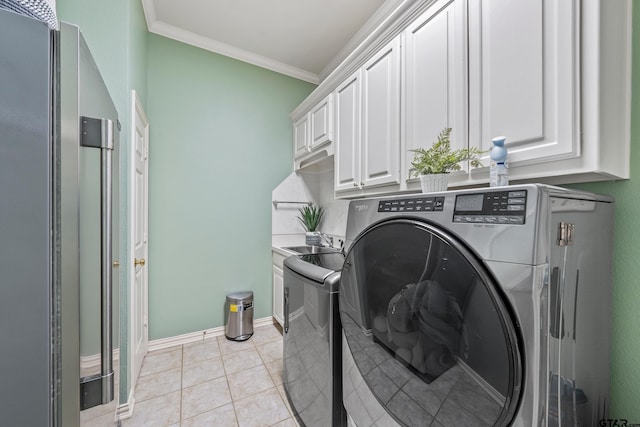 laundry room featuring washing machine and clothes dryer, baseboards, ornamental molding, light tile patterned floors, and cabinet space