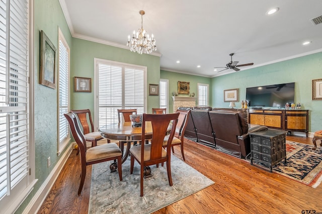 dining area featuring visible vents, wood finished floors, recessed lighting, a fireplace, and baseboards