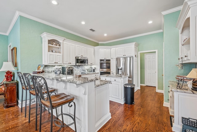 kitchen featuring visible vents, appliances with stainless steel finishes, a peninsula, white cabinetry, and open shelves