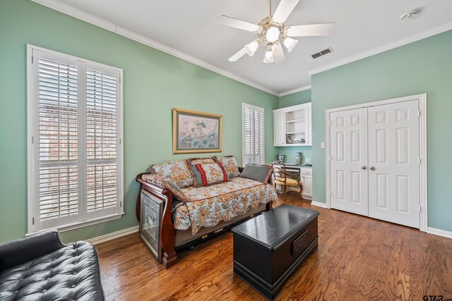 bedroom featuring visible vents, multiple windows, and wood finished floors