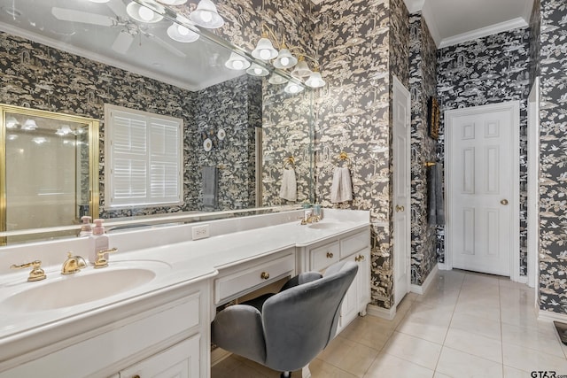 full bathroom with tile patterned floors, wallpapered walls, crown molding, and a sink