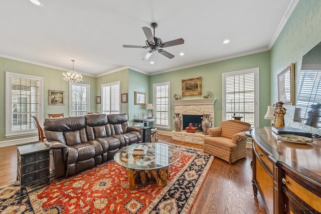 living area with plenty of natural light, dark wood-type flooring, a fireplace, and crown molding