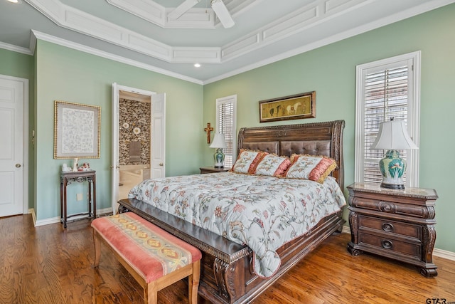 bedroom with ensuite bath, crown molding, baseboards, and wood finished floors