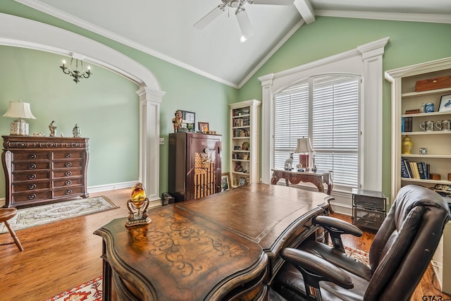 office space with wood finished floors, lofted ceiling with beams, decorative columns, arched walkways, and ceiling fan with notable chandelier