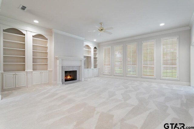 6529 Salisbury Ln, Tyler, TX 75703 - unfurnished living room featuring light colored carpet, visible vents, ceiling fan, ornamental molding, and a fireplace