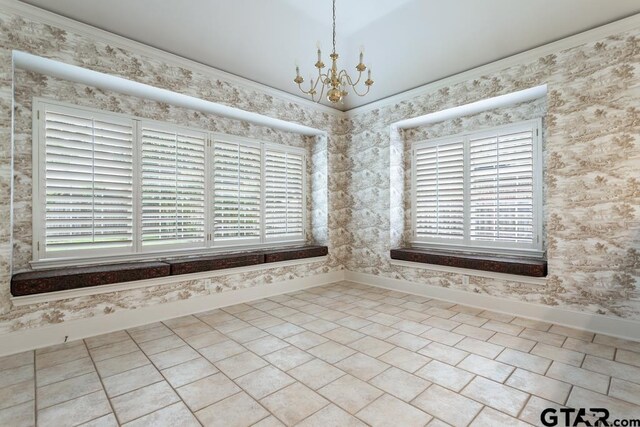 6529 Salisbury Ln, Tyler, TX 75703 - spare room featuring a chandelier, plenty of natural light, wallpapered walls, and baseboards