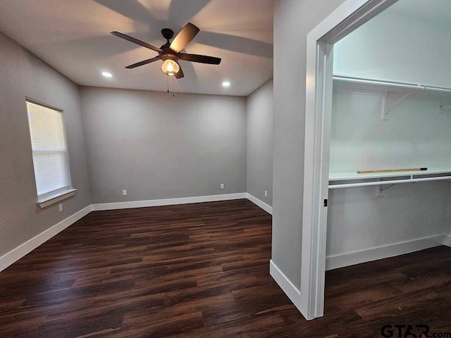 spare room featuring ceiling fan and dark hardwood / wood-style flooring