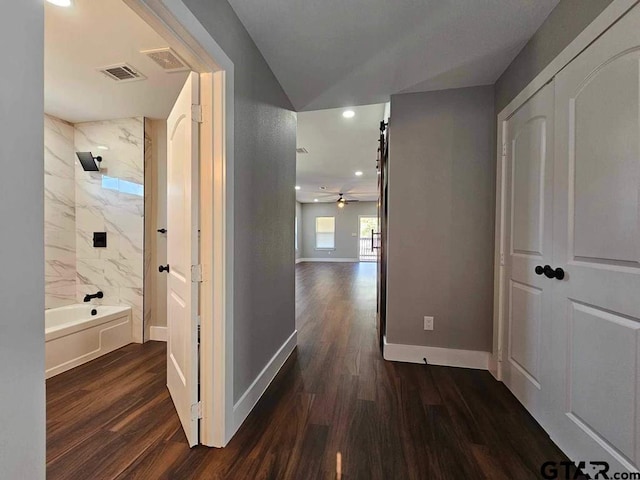 hallway with dark hardwood / wood-style flooring