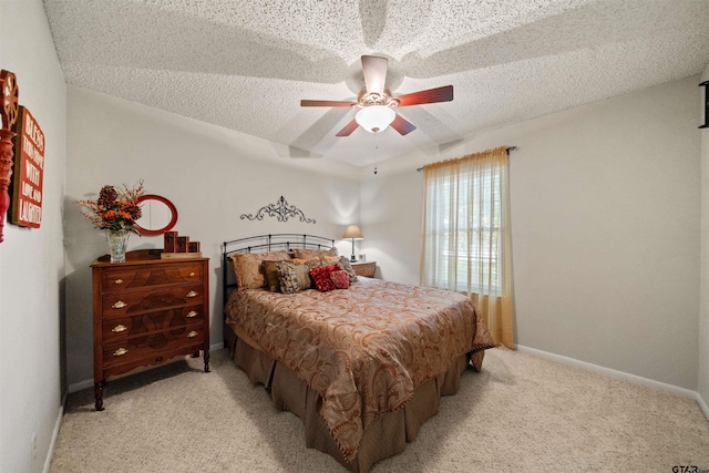 812 Jeffery Dr, Tyler, TX 75703 - bedroom with light carpet, a textured ceiling, a ceiling fan, and baseboards