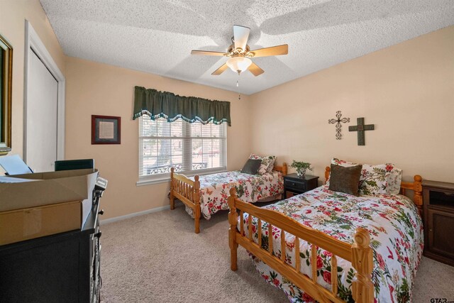 812 Jeffery Dr, Tyler, TX 75703 - bedroom featuring carpet, a textured ceiling, a ceiling fan, baseboards, and a closet