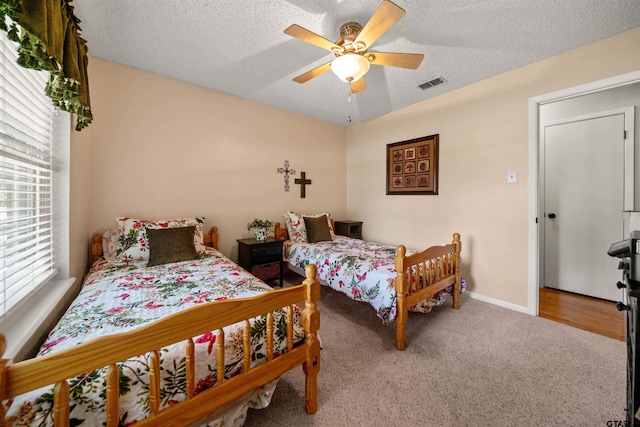 812 Jeffery Dr, Tyler, TX 75703 - carpeted bedroom with a textured ceiling, ceiling fan, and baseboards