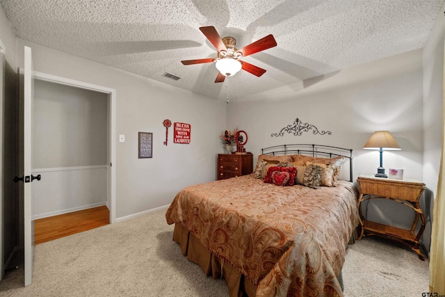 812 Jeffery Dr, Tyler, TX 75703 - carpeted bedroom featuring a textured ceiling, a ceiling fan, and baseboards
