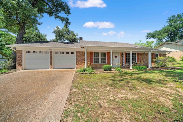 812 Jeffery Dr, Tyler, TX 75703 - single story home with a garage, brick siding, concrete driveway, a porch, and a front yard