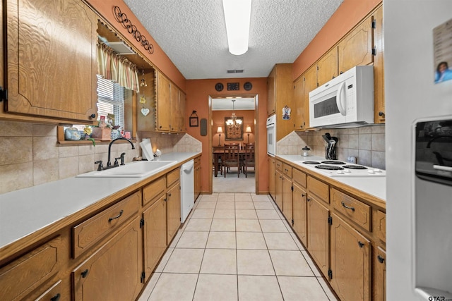812 Jeffery Dr, Tyler, TX 75703 - kitchen with white appliances, a sink, light countertops, a textured ceiling, and decorative backsplash