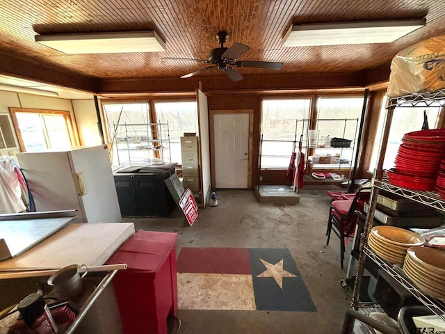 misc room with a wealth of natural light, ceiling fan, and concrete flooring