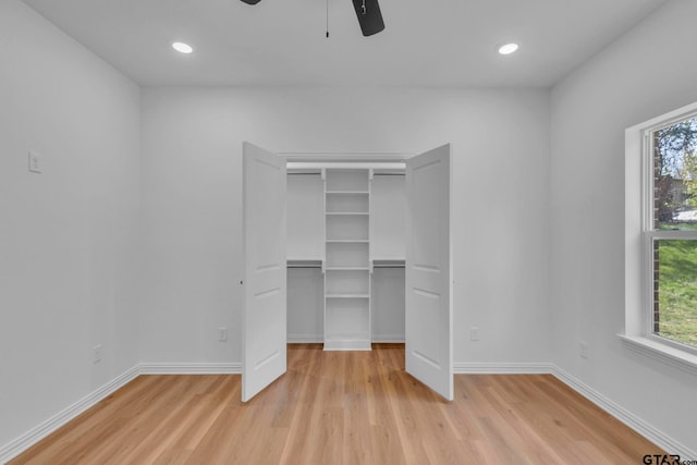 1410 W Connally St, Tyler, TX 75701 - unfurnished bedroom with light wood-style floors, a spacious closet, multiple windows, a closet, and recessed lighting