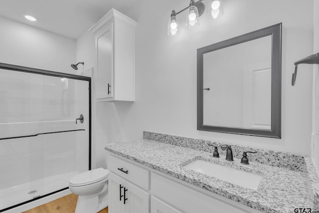 1410 W Connally St, Tyler, TX 75701 - bathroom featuring a shower stall, vanity, and wood finished floors