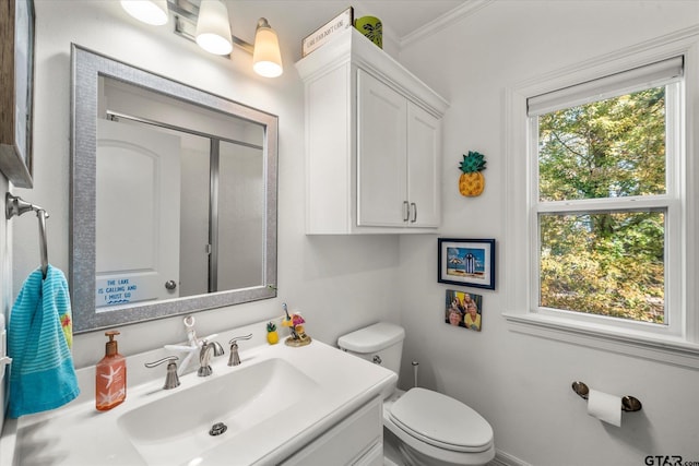 bathroom with toilet, ornamental molding, and vanity