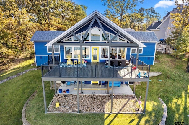 back of house featuring a patio, a wooden deck, and a lawn