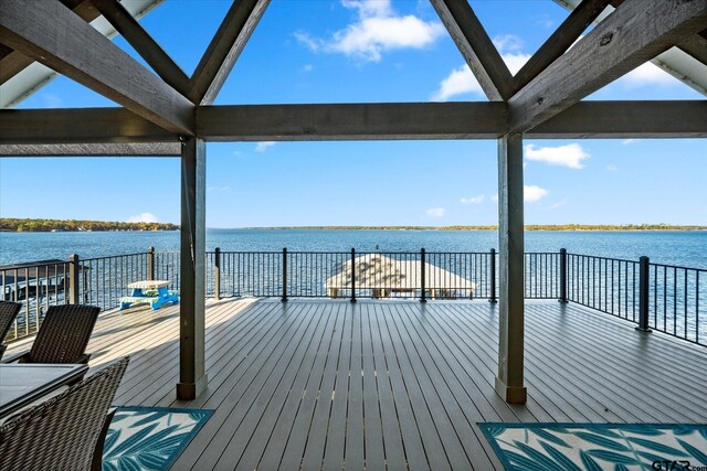 view of dock with a deck with water view