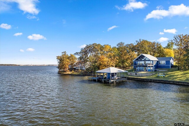 dock area featuring boat lift and a water view