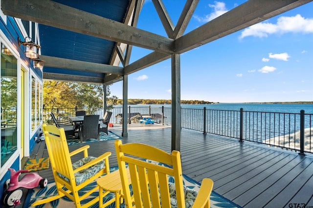 wooden deck featuring outdoor dining space and a water view