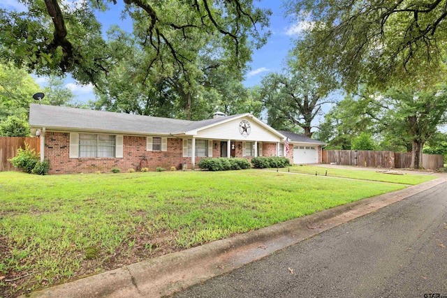 single story home with a garage and a front lawn