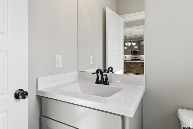 bathroom with toilet and vanity