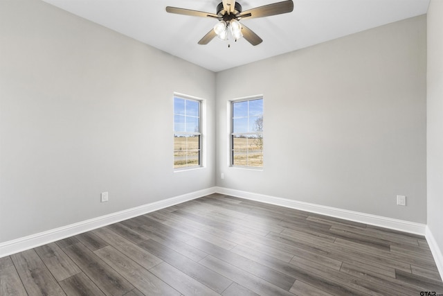 empty room with ceiling fan and dark hardwood / wood-style floors