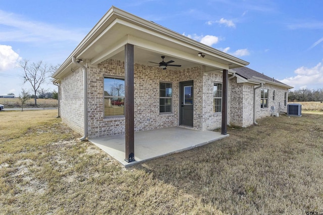 rear view of house featuring a patio area, a yard, central AC unit, and ceiling fan