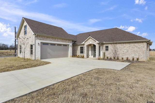 view of front of house with a garage and a front yard