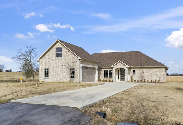 view of front of property with a front lawn and a garage