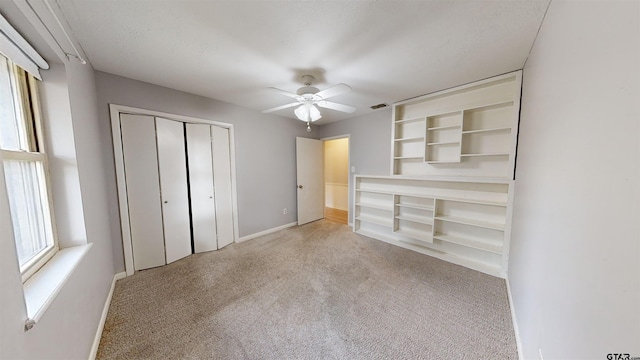 unfurnished bedroom with a closet and ceiling fan