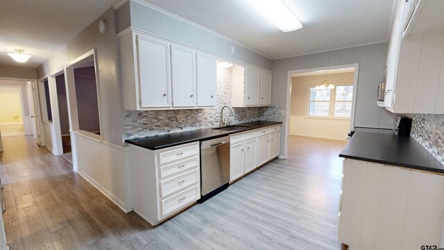 kitchen with tasteful backsplash, stainless steel dishwasher, stove, and white cabinets