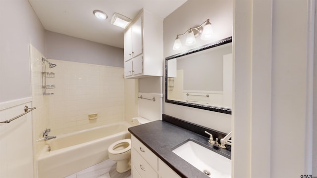 full bathroom featuring tiled shower / bath, vanity, and toilet