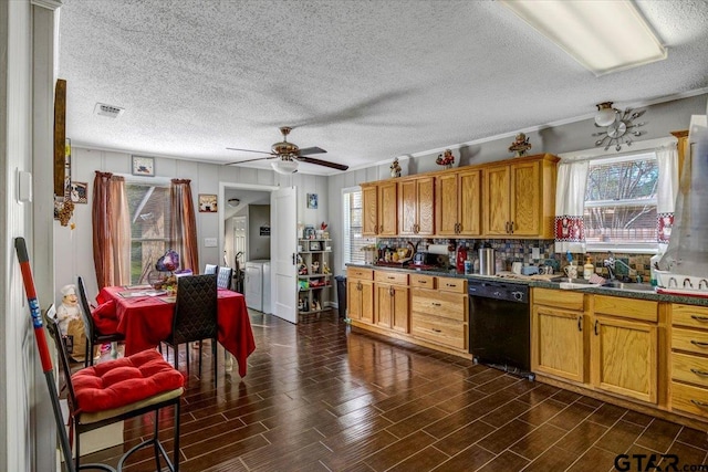 kitchen featuring a ceiling fan, a healthy amount of sunlight, black dishwasher, and independent washer and dryer