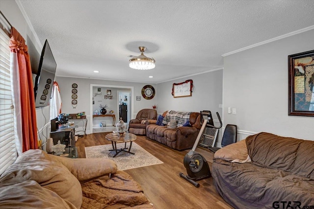 living room featuring recessed lighting, wood finished floors, a textured ceiling, and ornamental molding