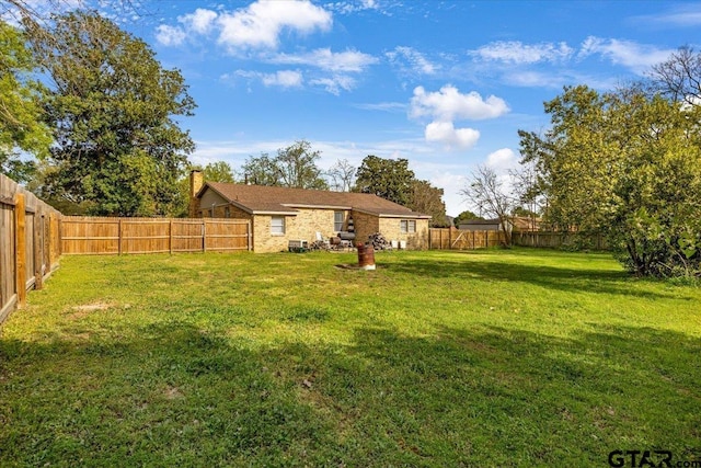 view of yard with a fenced backyard