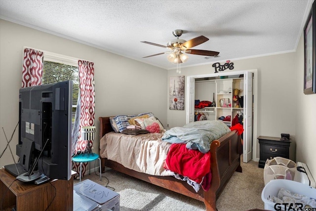 bedroom with carpet, a textured ceiling, ceiling fan, and crown molding